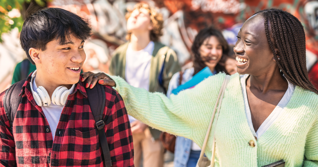 Teens walking together smiling and showing support.