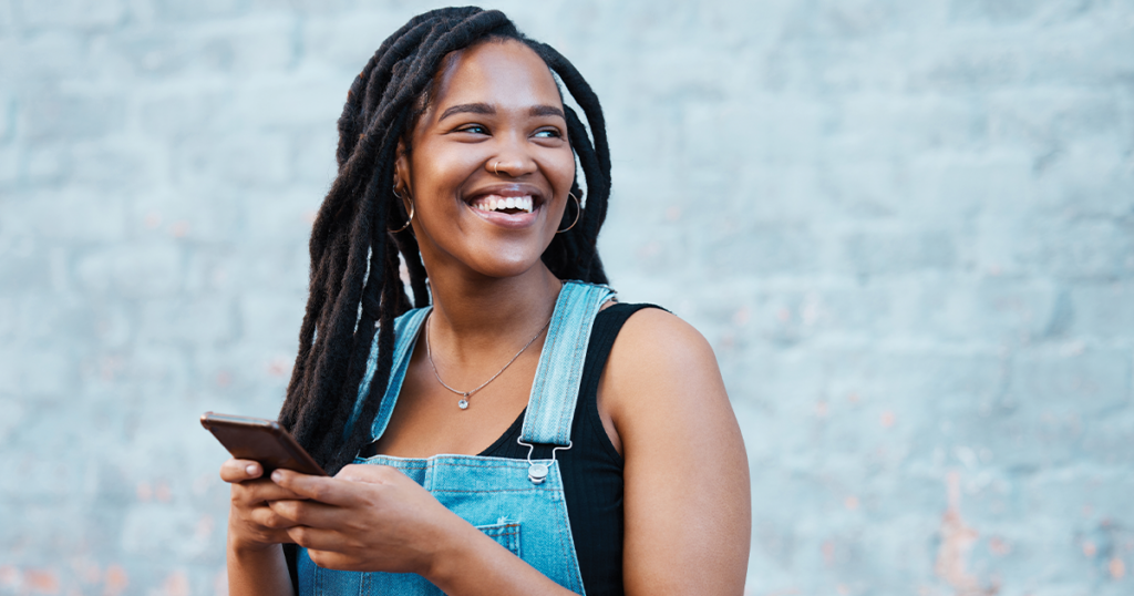 Teen holding her phone understanding the link between social media and substance use.