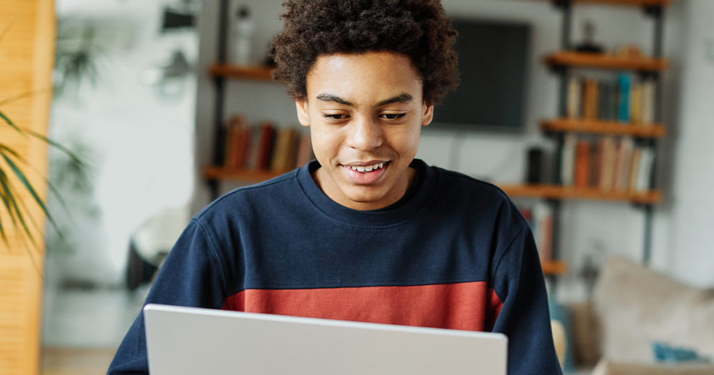 Teen looking at laptop learning the truth about vaping.