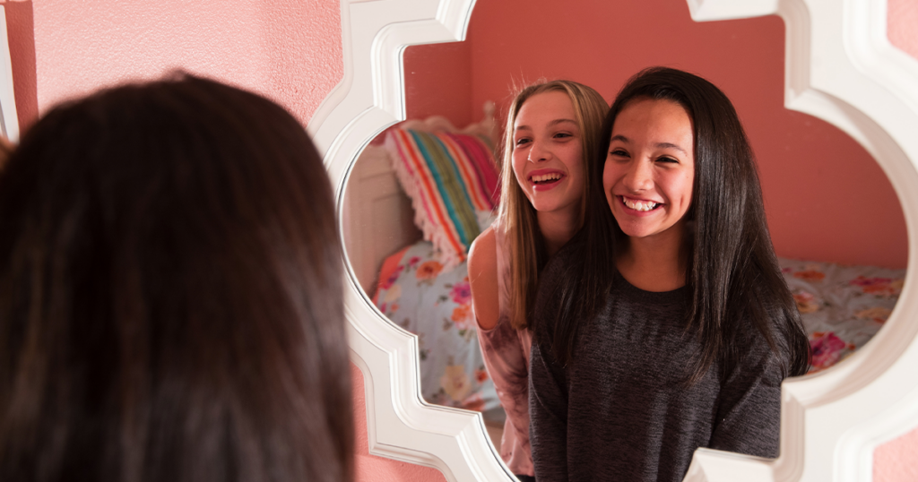 Boosting your Teen's confidence, teens smiling with a positive self image.